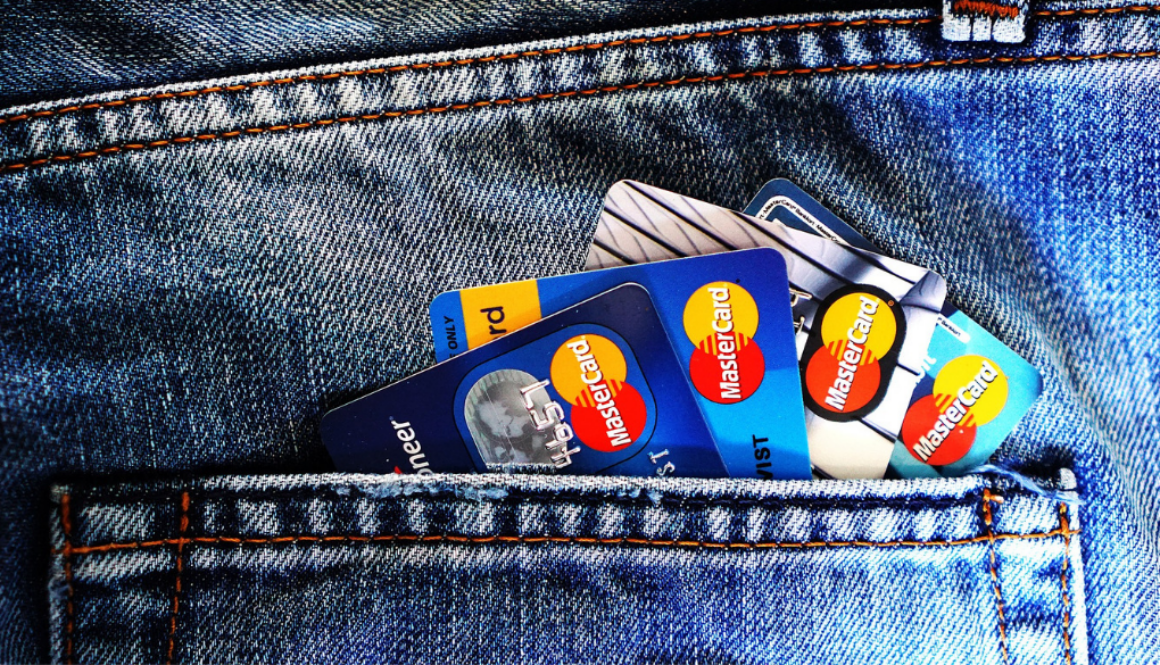 Credit and debit cards in a blue jeans pocket, representing tools for tax planning and accounting with Wisconsin fiduciary advisors.