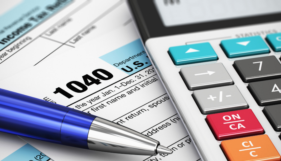A tax form 1040, calculator, and blue pen on a desk illustrate tax planning and financial advisory services in Wisconsin.