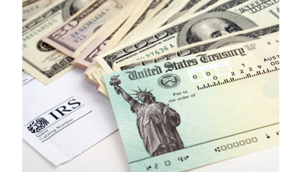 An IRS envelope, U.S. Treasury check, and cash emphasize why Wisconsin fiduciary advisors stress tax planning and financial planning.
