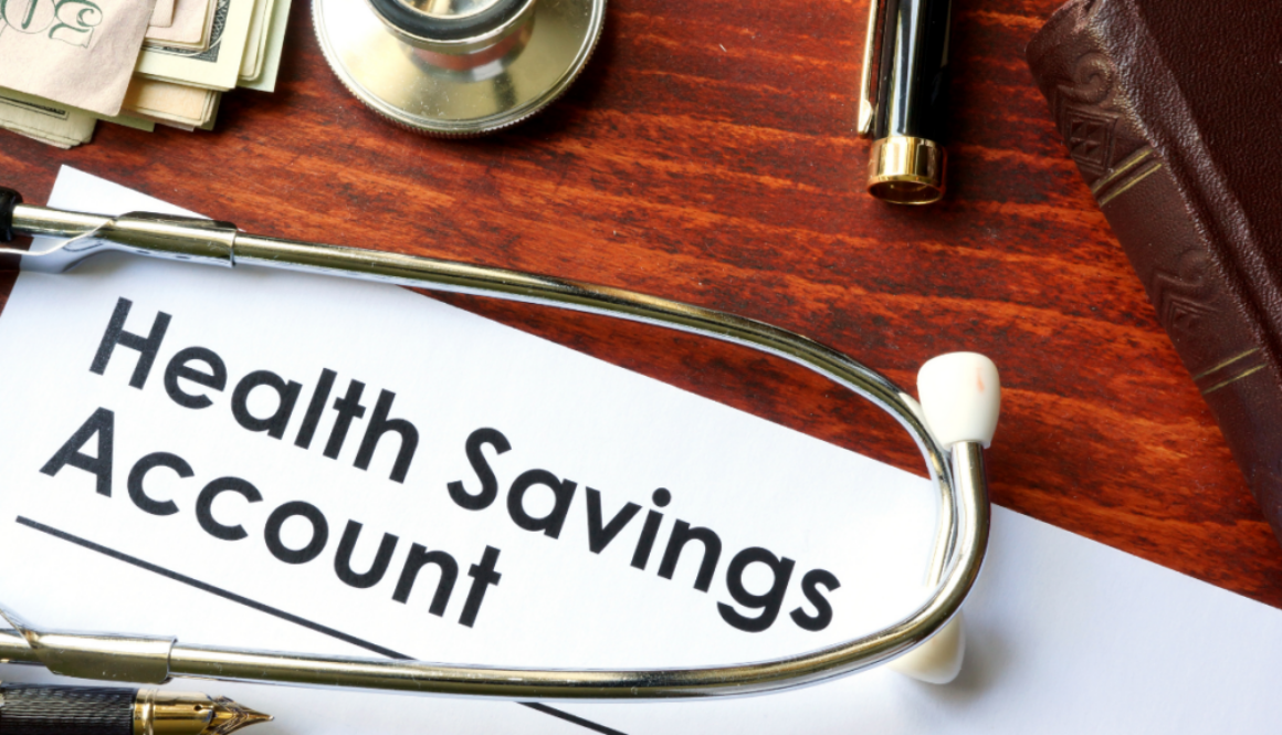 A stethoscope and Health Savings Account paper on a desk with cash, a pen, book, and financial planning documents in Wisconsin.