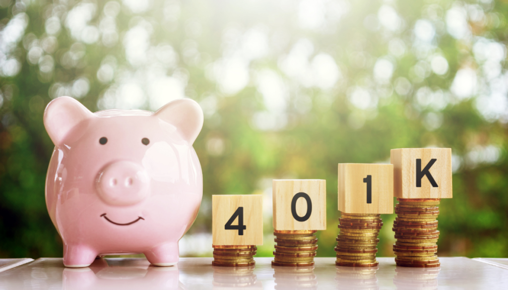 A pink piggy bank and stacked coins with 401K blocks symbolize financial planning with fiduciary advisors in Wisconsin.