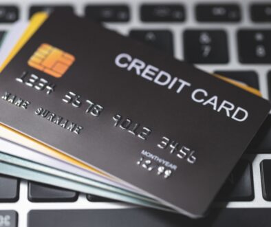 Stacks of credit cards on a laptop keyboard.